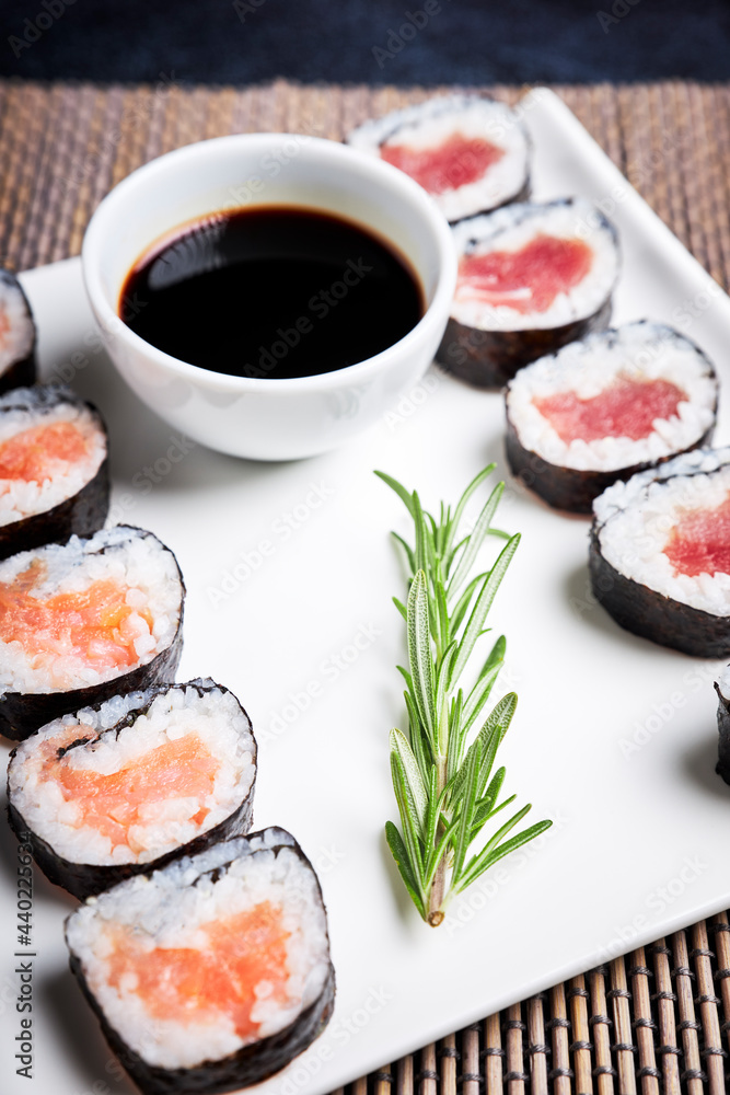 Close-up of plate with sushi and bowl of soy sauce. Asian food. Healthy food concept Close-up of plate with sushi and bowl of soy sauce. Asian food. Healthy food concept
