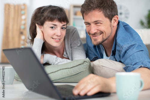 portrait of happy young couple using laptop