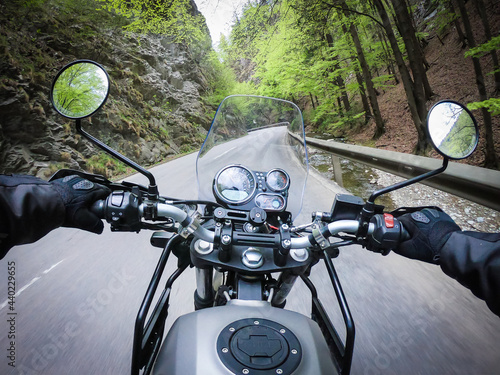 Riding motorcycle through a narrow mountain street fast © Photofex