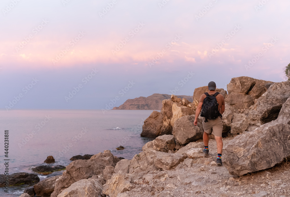one hiker men walking on the shore of Black sea in the Crimea