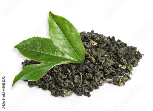 Dry green tea and fresh leaves on white background