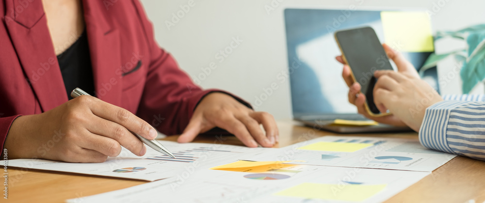 Two business leaders talk about charts, financial graphs showing results are analyzing and calculating planning strategies, business success building processes Two business leaders talk about charts, financial graphs showing results are analyzing and calculating planning strategies, business success building processes