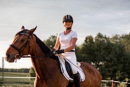 Portrait of young laughing woman on horse. Concept of happiness and enjoyment of wildlife. Sports and health.Role model. Active recreation.