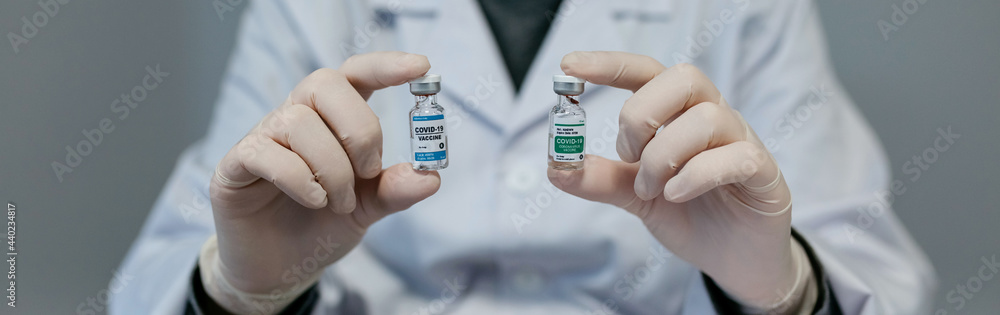 Unrecognizable female doctor showing two coronavirus vaccine options