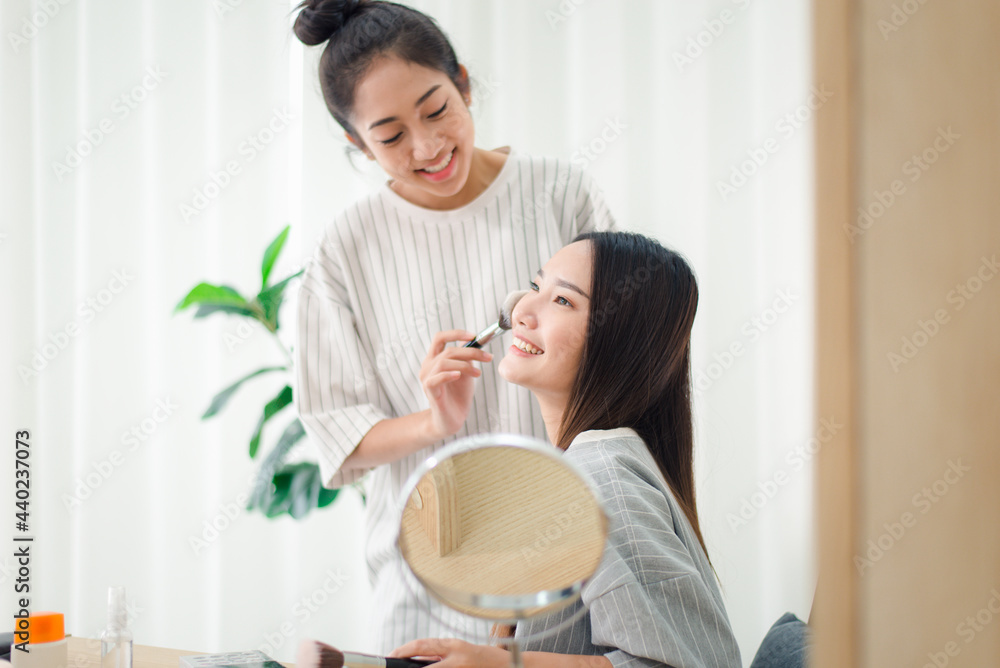 Beautiful two young asian women applying and makeup together at home,Beauty woman concept Beautiful two young asian women applying and makeup together at home,Beauty woman concept