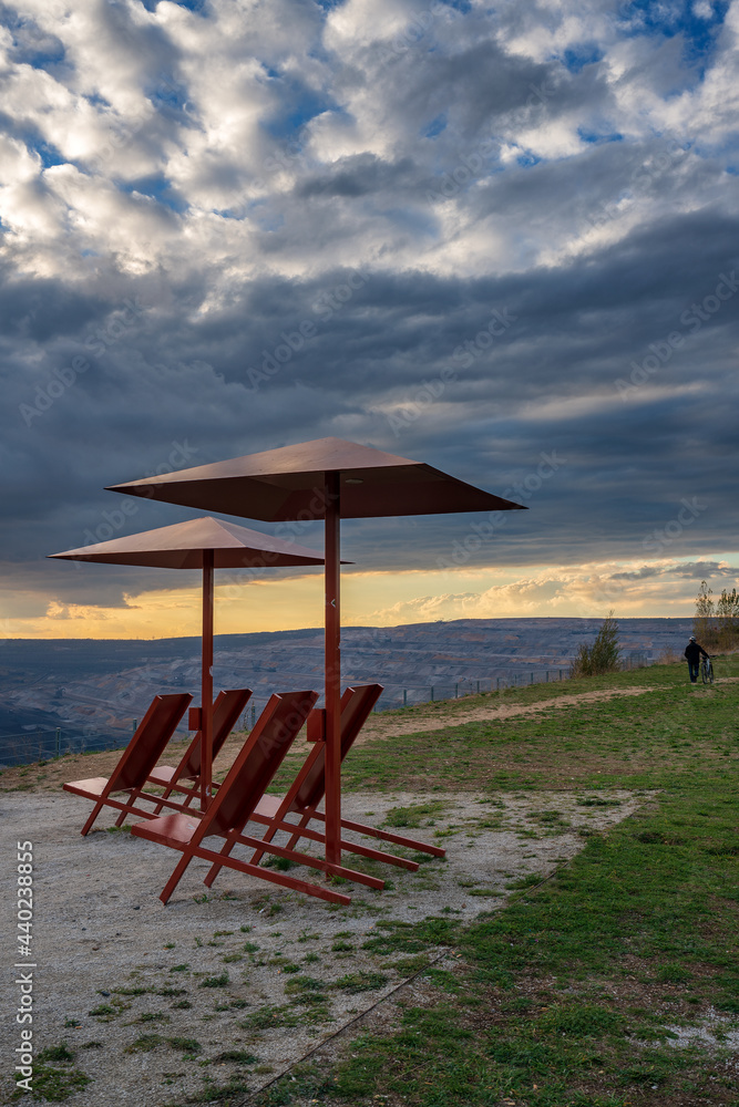 Sun loungers and parasols at the Hambach opencast mine vantage point , Germany.