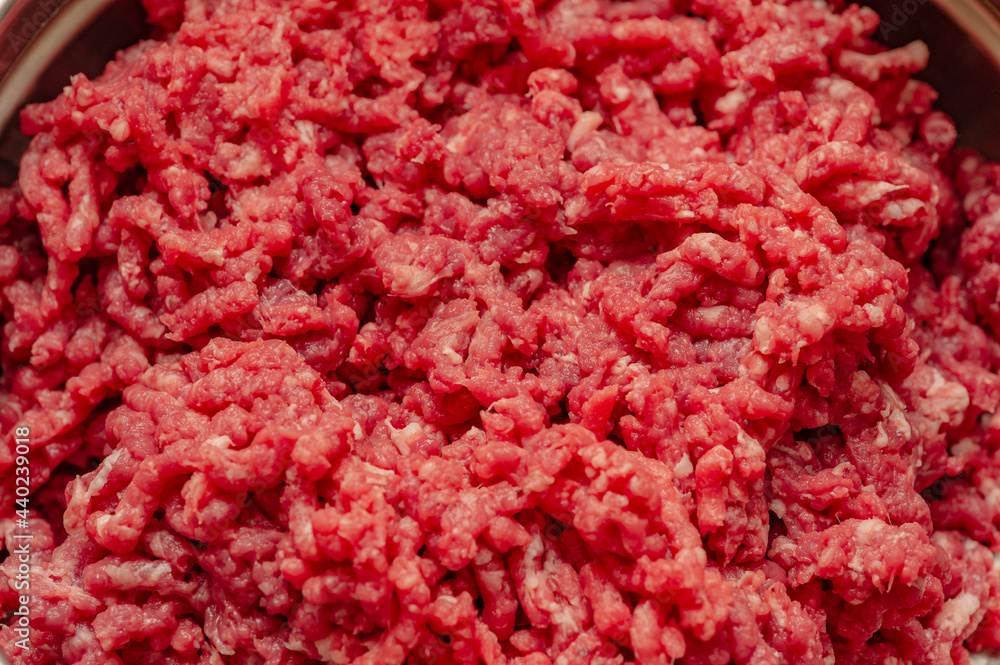 Minced beef close-up in a metal plate. Minced cutlets cooking for dinner. beef, grinder, raw, food, meat, cooking. Minced beef close-up in a metal plate. Minced cutlets cooking for dinner. beef, grinder, raw, food, meat, cooking.