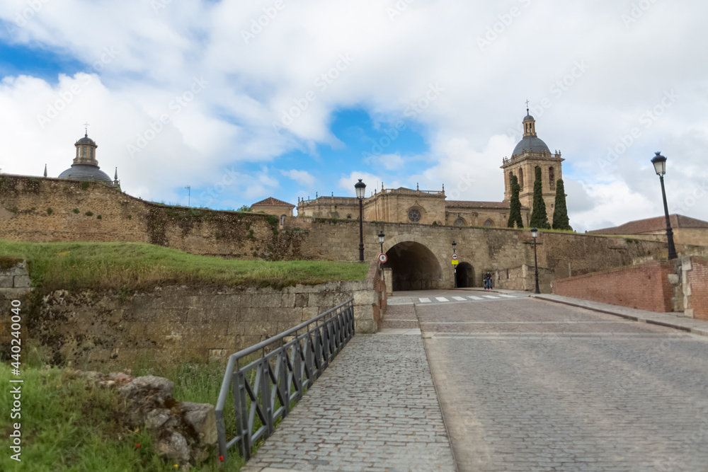 Majestic front view at the fortress gate and iconic spanish Romanesque architecture building at the Cuidad Rodrigo cathedral, towers and domes, downtown city