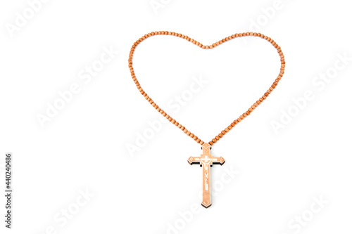 Wooden christian cross necklace isolated on white background.