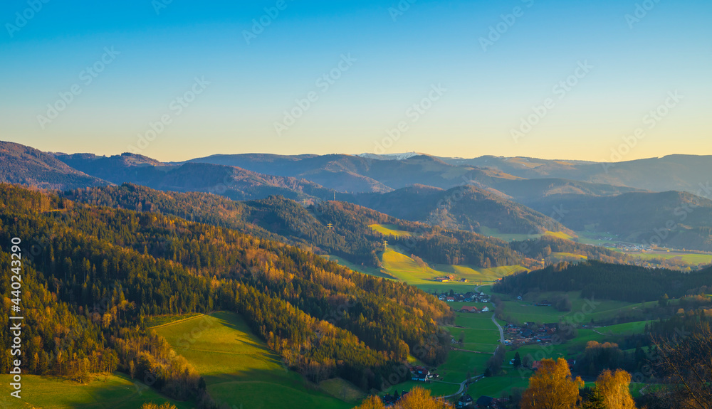 Naklejka premium Germany, Schwarzwald aerial panorama nature landscape view above colorful valley and village houses from above at sunset in spring