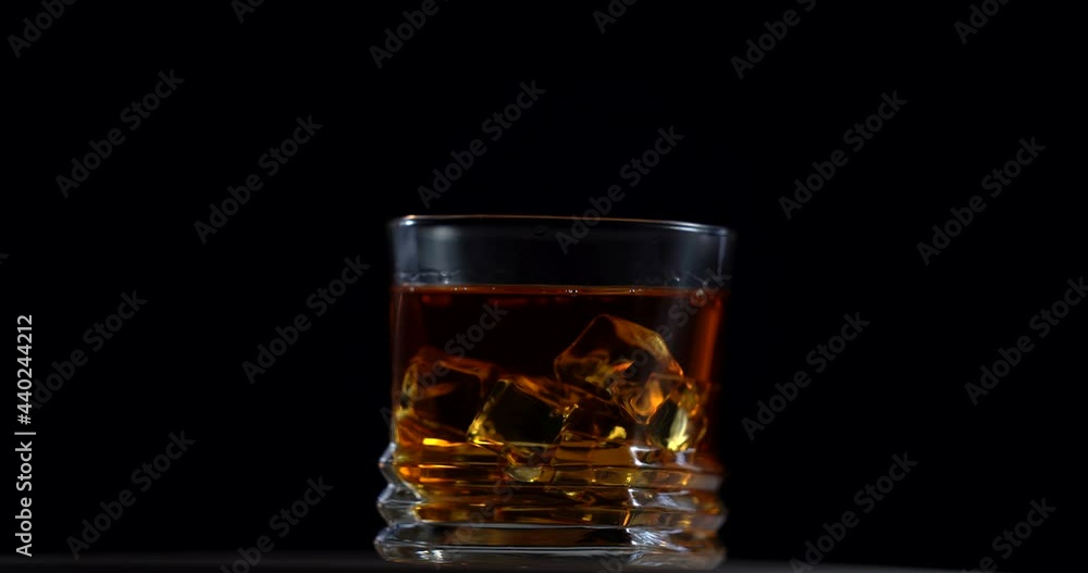 Super Slow Motion Shot of Pouring Whiskey into Glass at 100fps with Camera Movement. Rotation glass Super Slow Motion Shot of Pouring Whiskey into Glass at 100fps with Camera Movement. Rotation glass