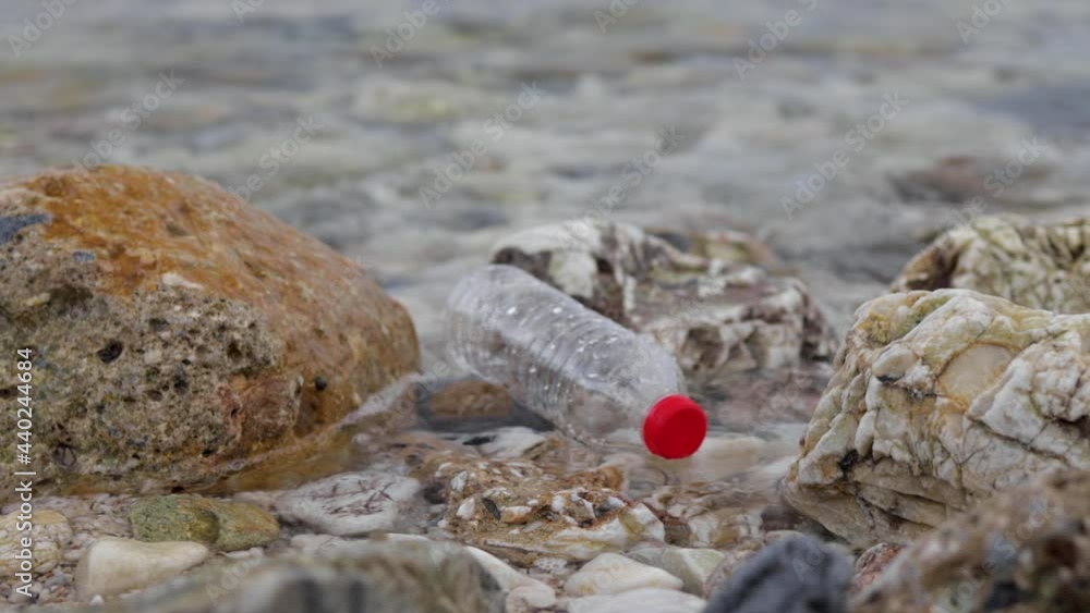 Empty plastic bottle floats in the sea. Environmental pollution and ecological problem concept Empty plastic bottle floats in the sea. Environmental pollution and ecological problem concept