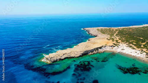Aerial view of coastline of Cyprus beach.The steep stone cliffs and deep blue sea waves crushing in coves. beautiful turquoise waters of mediterranean