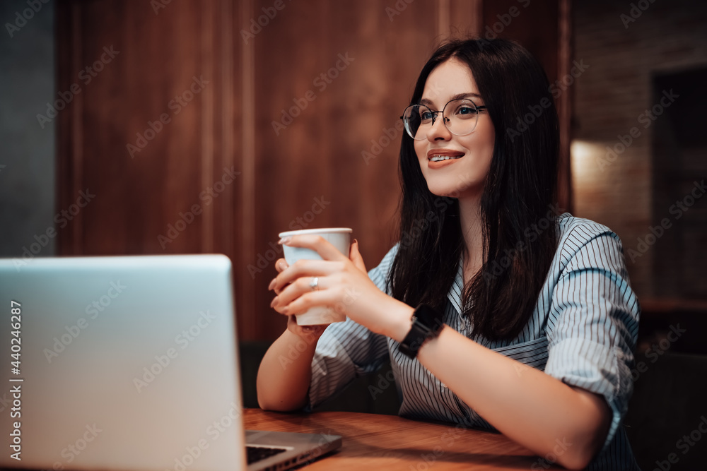 Business woman smiling sitting cafe coffee break open space work laptop have lunch chilling after hard working day. Lady dressed striped shirt stylish glasses looking away copyspace Business woman smiling sitting cafe coffee break open space work laptop have lunch chilling after hard working day. Lady dressed striped shirt stylish glasses looking away copyspace