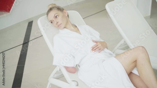 Woman with amputated hand relaxing in spa center
