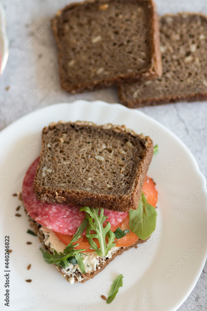 Cooked breakfast with coffee and sandwich. All this on a gray background