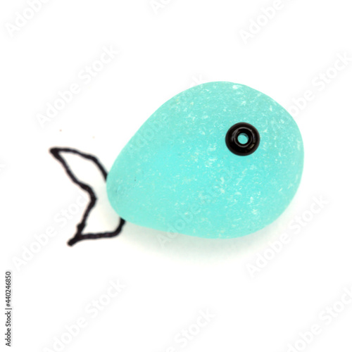 funny little fish made of a piece of seaglass, with sketchily drawn fins, isolated on white background
 photo