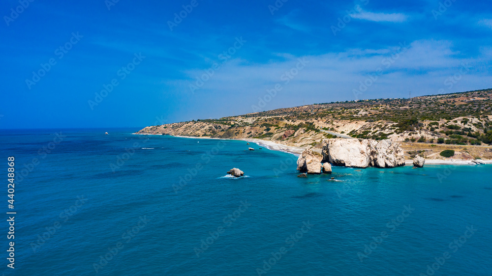 Fototapeta premium Cyprus. Aphrodite's rock aerial view Petra-Tu-Romiou. Bay of Aphrodite. Mediterranean sea. Seascape rocks. Paphos. Kouklia. The Cyprus beaches. Turquoise sea. Coast of the Republic of Cyp