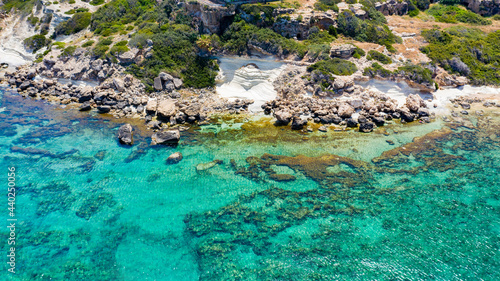 Aerial view of coastline of Cyprus beach.The steep stone cliffs and deep blue sea waves crushing in coves. beautiful turquoise waters of mediterranean
