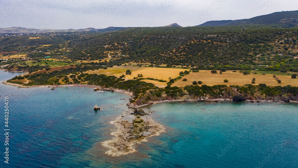 Aerial view of coastline of Cyprus beach.The steep stone cliffs and deep blue sea waves crushing in coves. beautiful turquoise waters of mediterranean