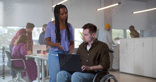 Wallpaper Mural Young man in wheelchair working with female colleague Torontodigital.ca