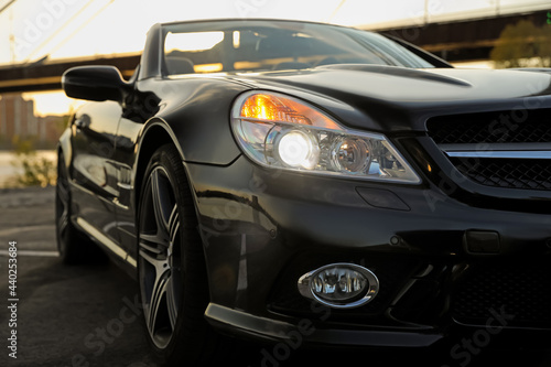 Luxury black convertible car outdoors, closeup view © New Africa