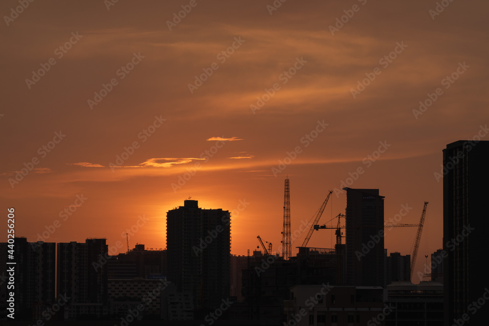 sunset over the city skyscape crane on building sunset over the city skyscape crane on building