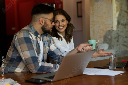  Colleagues in office. Businesswoman and businessman discussing work in office