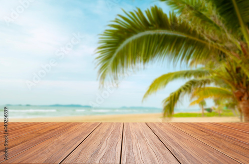 empty new wood table and blurred beach background. © noppadon