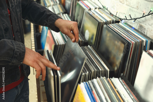 Man choosing vinyl records in store, closeup