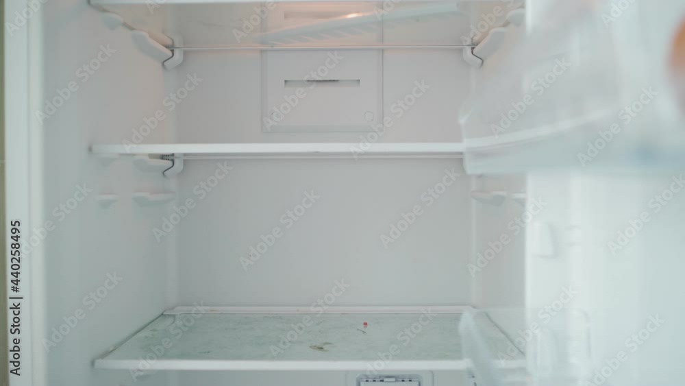 Unrecognizable Person Opens the Empty Refrigerator. Poverty and Economic Crisis Concept. No Money or Food. Shooting from the First Person. POV Unrecognizable Person Opens the Empty Refrigerator. Poverty and Economic Crisis Concept. No Money or Food. Shooting from the First Person. POV