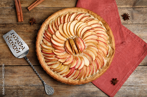 Delicious homemade apple tart on wooden table, flat lay