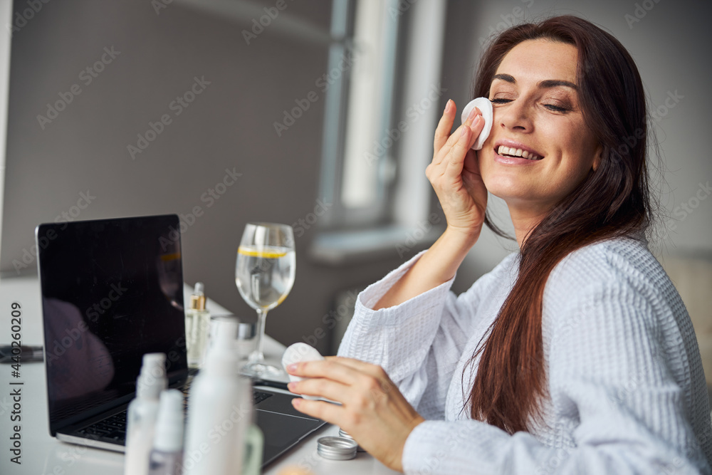 Amazing brunette female preparing skin for makeup Amazing brunette female preparing skin for makeup