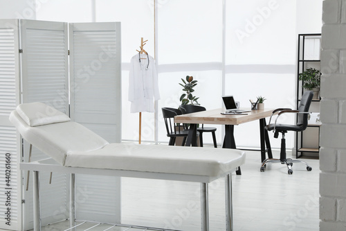 Modern medical office interior with couch. Doctor's workplace