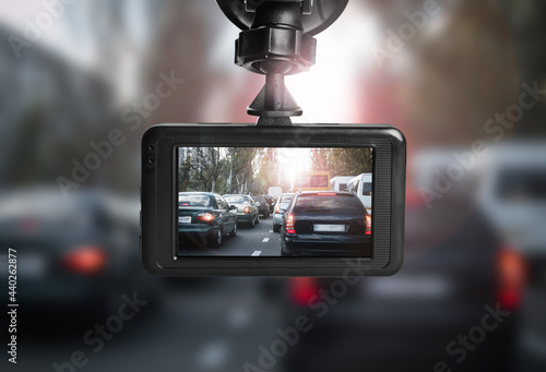 Fotografie Modern dashboard camera mounted in car, view of road during driving