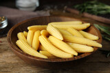 Fresh baby corn cobs on wooden table, closeup