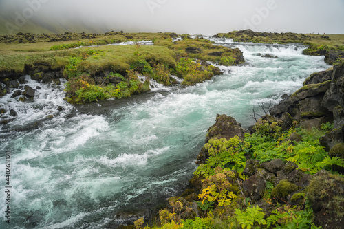 Foss river and Icelandic landscape. Scandinavian amazing nature.