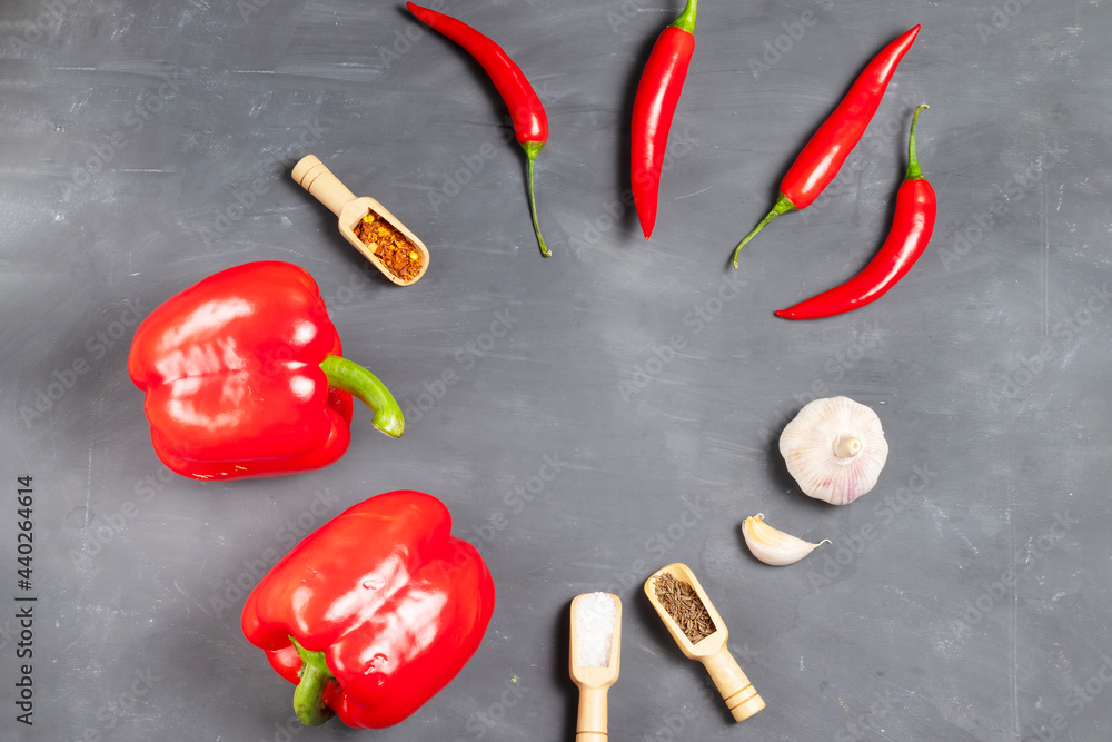 Ingredients for hot harissa sauce: bell peppers, chilli peppers, cumin, remaining spice, salt and garlic laid out in a circle on a chalk board сopy space Ingredients for hot harissa sauce: bell peppers, chilli peppers, cumin, remaining spice, salt and garlic laid out in a circle on a chalk board сopy space