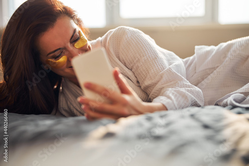 Relaxed brunette female having pleasant online conversation