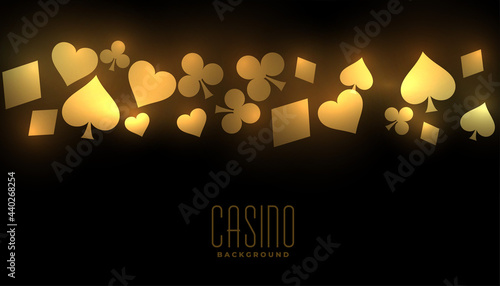 golden casino background with card suit symbols