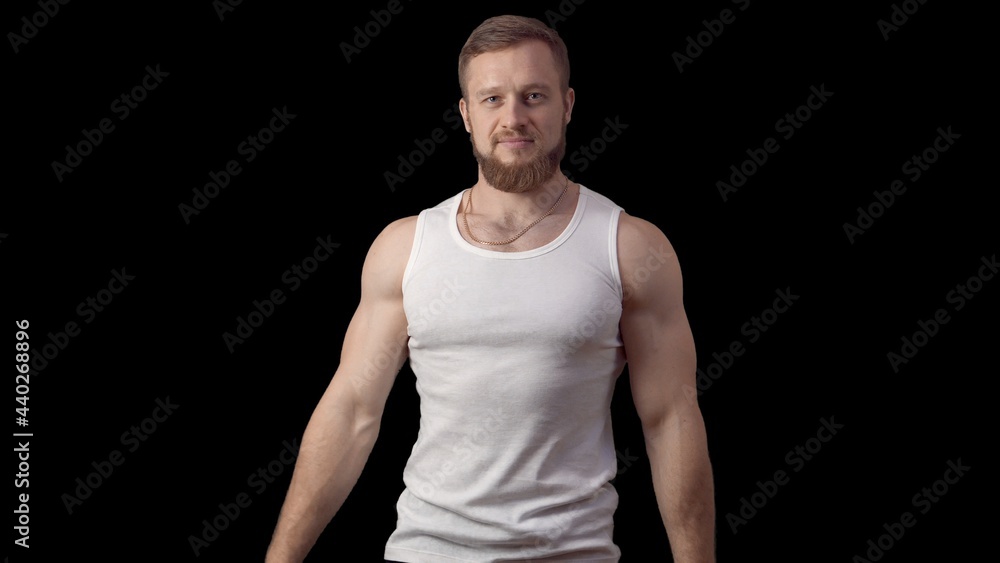 Caucasian man with a beard looking at the camera. Look ahead on a black background. High quality photo Caucasian man with a beard looking at the camera. Look ahead on a black background. High quality photo