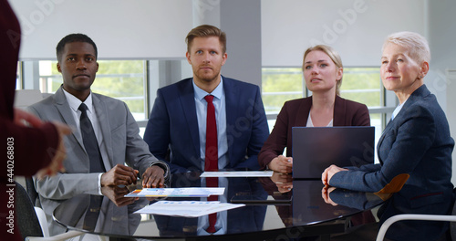 Multiethnic businesspeople sitting at table on corporate meeting