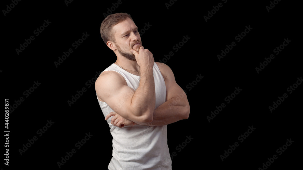 The man looks sideways and thinks. I thought about it. The hand is near the face. Soaper. Caucasian man with a beard. High quality photo The man looks sideways and thinks. I thought about it. The hand is near the face. Soaper. Caucasian man with a beard. High quality photo