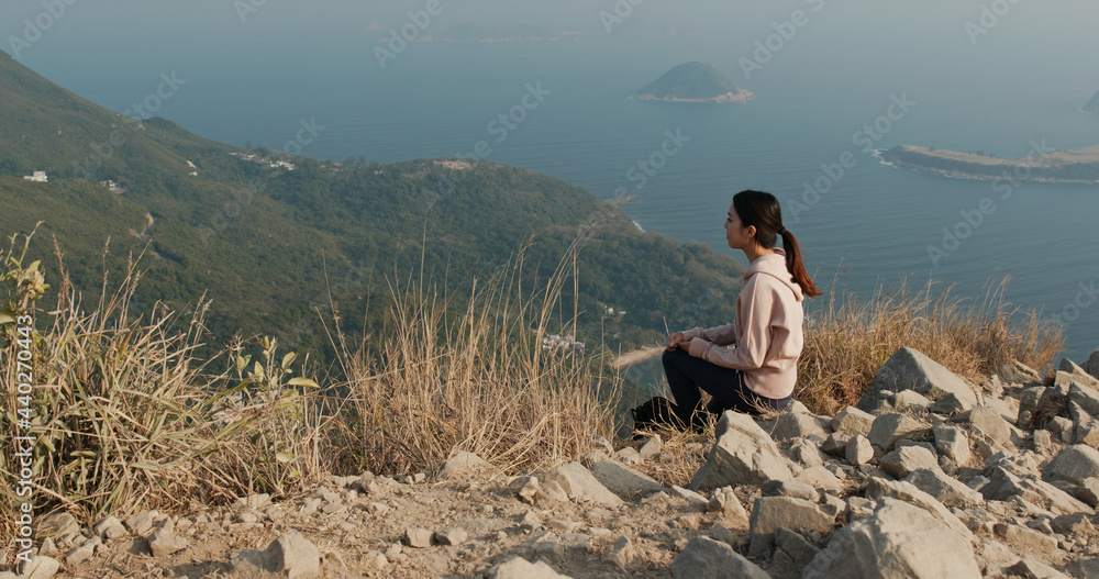 Woman sit on the top of mountain