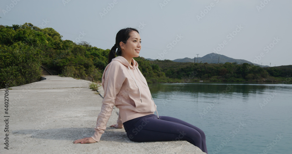 Woman sit on the ground and enjoy the sea view