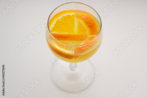 Closeup of kruszon (cruchon) – alcoholic drink with white wine and oranges. photo