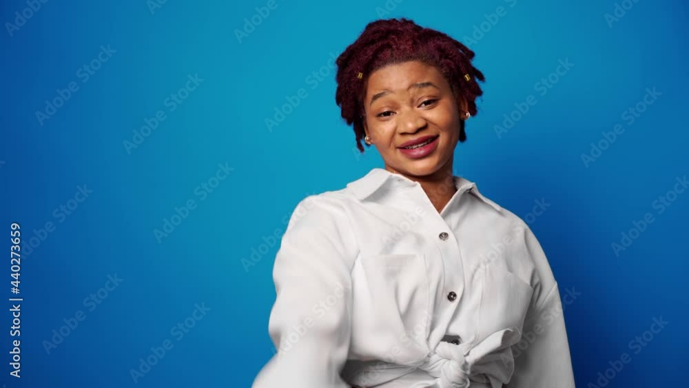 Dissatisfied afro american woman showing her refusal, denies something against blue background Dissatisfied afro american woman showing her refusal, denies something against blue background