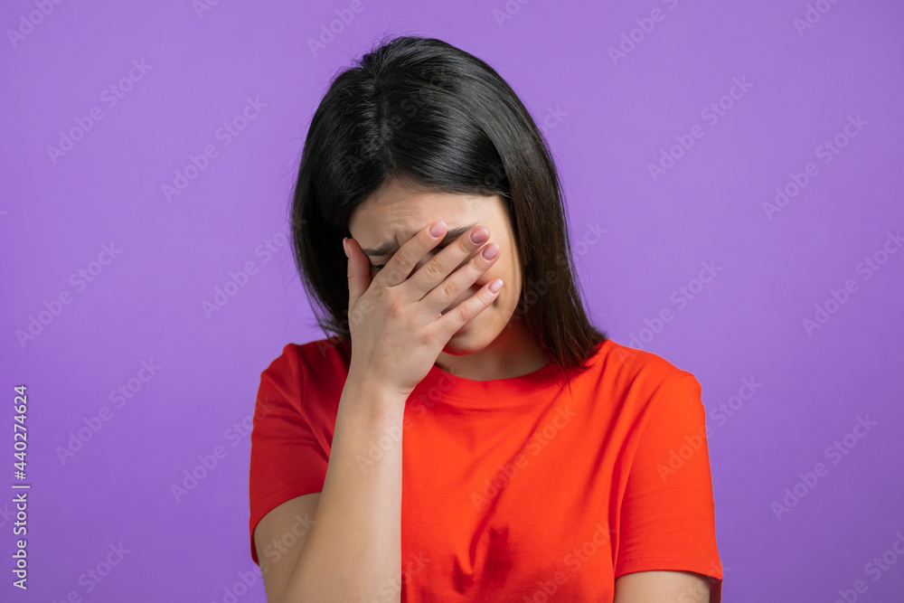 Portrait of young woman doing facepalm gesture, like no, I forgot. Unhappy woman feeling sorrow, regret, drama, failure. She isolated on violet wall Portrait of young woman doing facepalm gesture, like no, I forgot. Unhappy woman feeling sorrow, regret, drama, failure. She isolated on violet wall