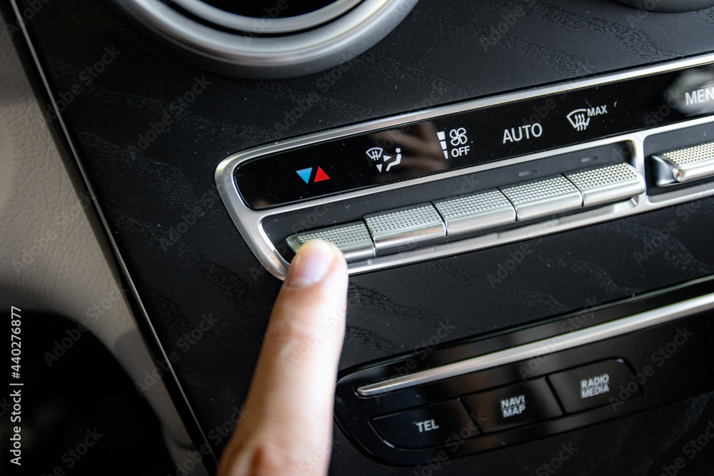 Fototapeta premium hand holding with car climat control 