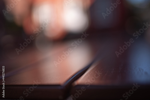 Dark bokeh background with empty wooden deck table for product montage display